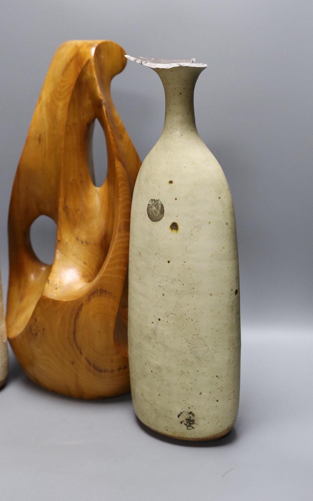 A carved elm abstract sculpture and two Joanna Constantinidis Studio pottery vases, tallest 44cm